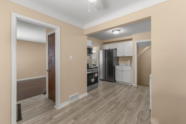 kitchen with white cabinetry, ceiling fan, stainless steel appliances, and light wood-type flooring