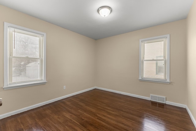 unfurnished room featuring dark hardwood / wood-style flooring