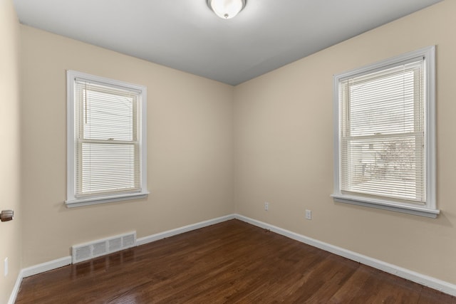 unfurnished room with dark hardwood / wood-style floors