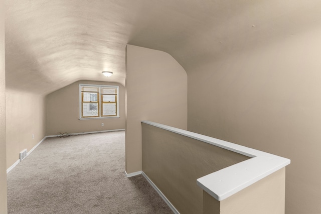 additional living space with lofted ceiling and carpet