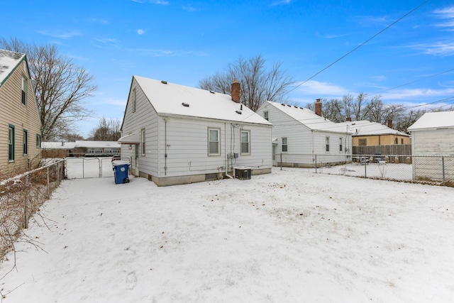 snow covered property with central air condition unit