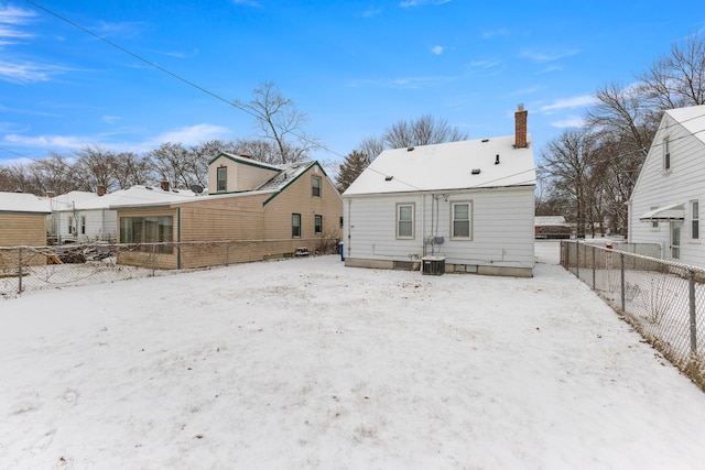 snow covered property with cooling unit