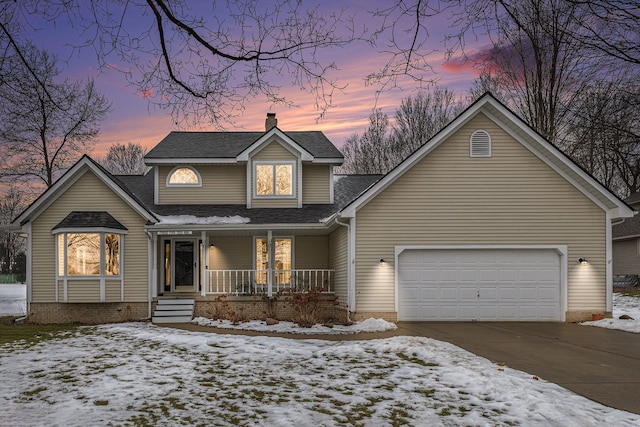 view of front of property featuring a garage and covered porch