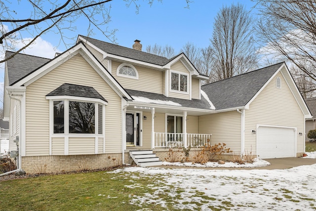 view of front of house featuring a garage, covered porch, and a lawn