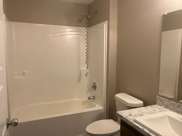 bathroom featuring toilet, vanity, and bathing tub / shower combination