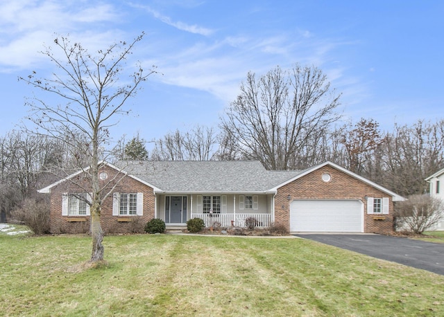 single story home featuring a garage, a front yard, and covered porch