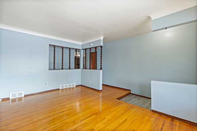 spare room featuring wood-type flooring