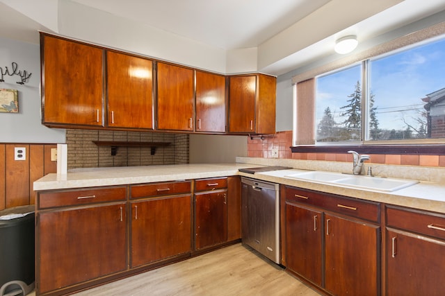 kitchen featuring tasteful backsplash, sink, light hardwood / wood-style flooring, and dishwasher