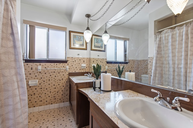 bathroom featuring vanity and tile walls