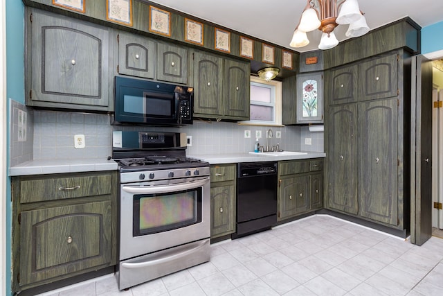 kitchen with a sink, a notable chandelier, tile countertops, backsplash, and black appliances