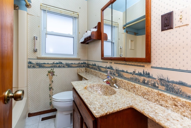 bathroom with wallpapered walls, toilet, vanity, and tile patterned flooring