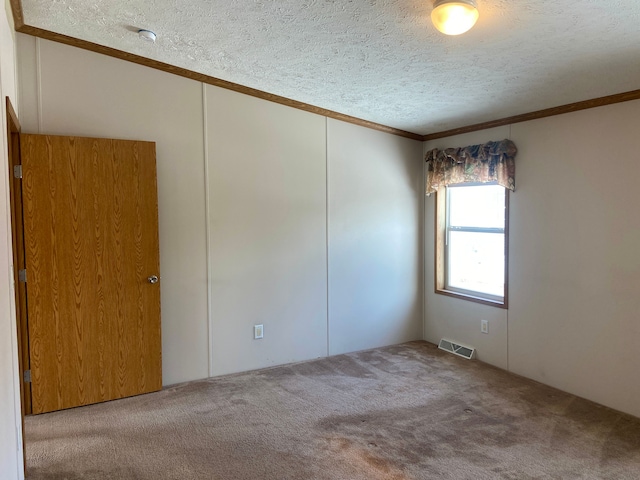 unfurnished room with crown molding, carpet flooring, and a textured ceiling