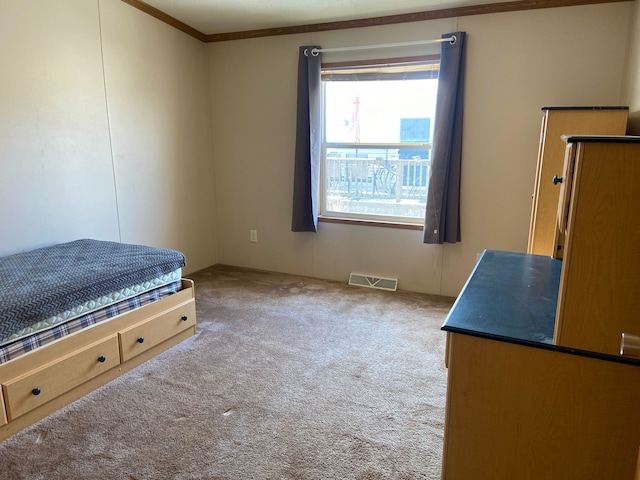 unfurnished bedroom with crown molding and carpet floors