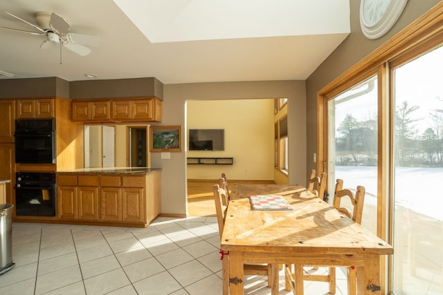 tiled dining area featuring ceiling fan