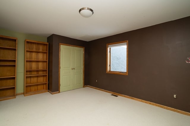 unfurnished bedroom featuring light carpet