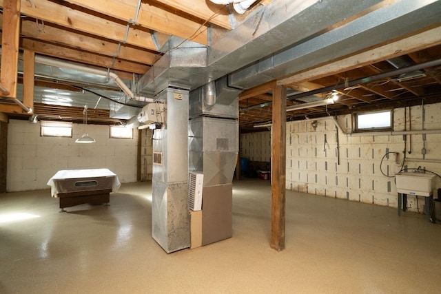 basement with heating unit and sink