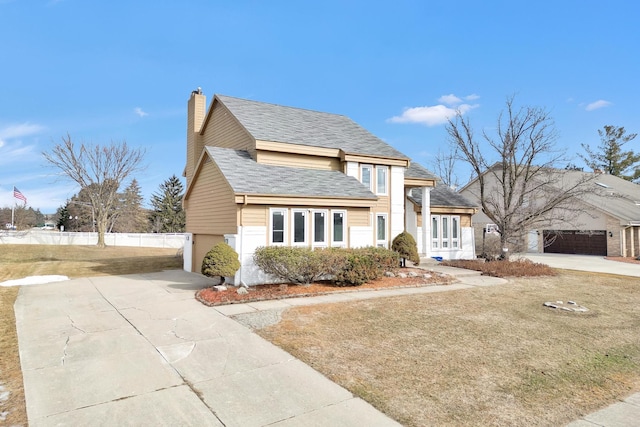 view of front of property with fence, roof with shingles, a chimney, a garage, and driveway