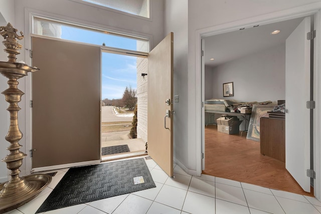 foyer entrance with recessed lighting and light tile patterned flooring