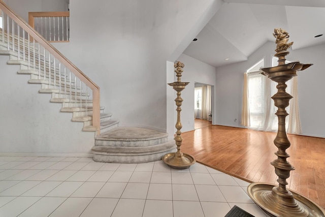 interior space with vaulted ceiling and stairway