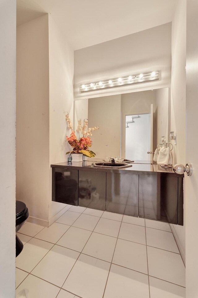 bathroom with tile patterned floors, vanity, and baseboards