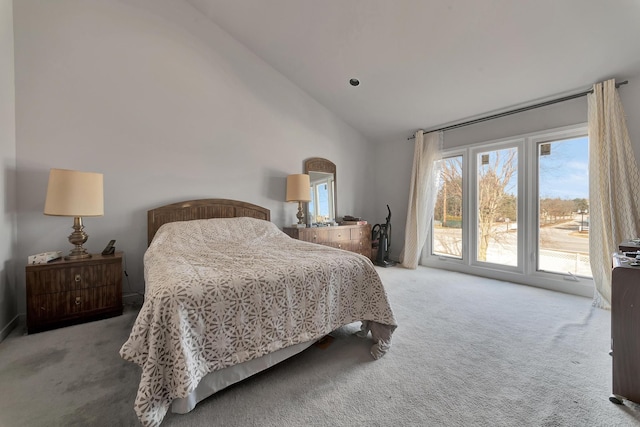 bedroom with access to outside, carpet flooring, and vaulted ceiling