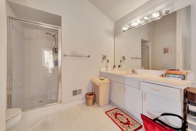 full bathroom featuring vanity, visible vents, a shower stall, vaulted ceiling, and tile patterned floors