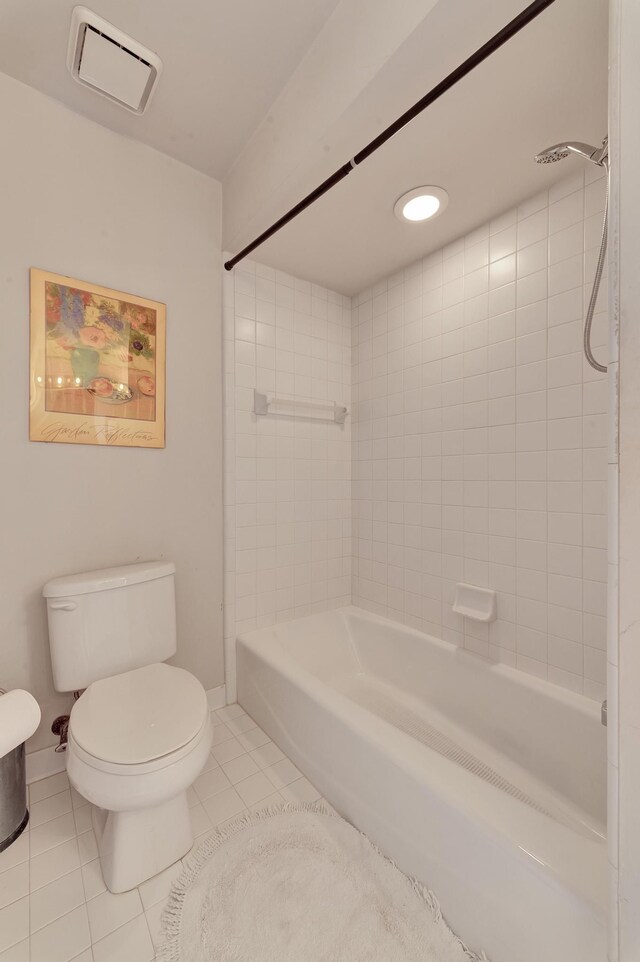 bathroom with visible vents, baseboards, toilet, shower / bath combination, and tile patterned floors