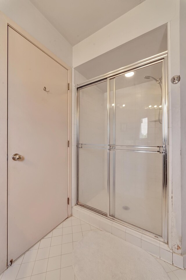 bathroom with tile patterned floors and a shower stall