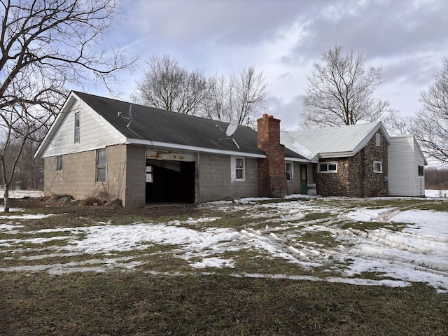 snow covered house with a garage