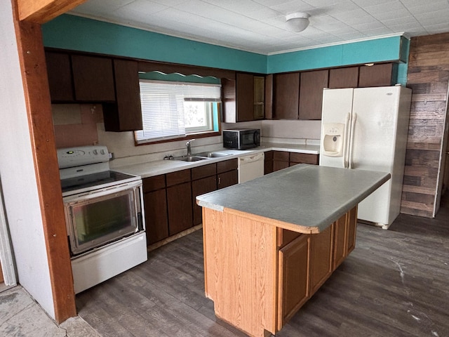 kitchen featuring sink, white appliances, dark hardwood / wood-style floors, a center island, and dark brown cabinetry