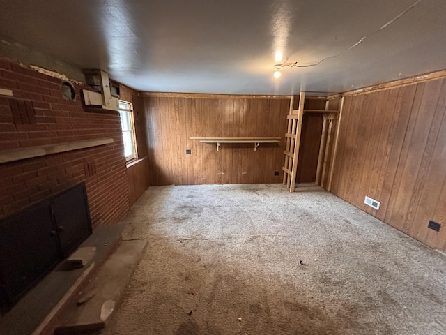 basement featuring carpet floors and wooden walls