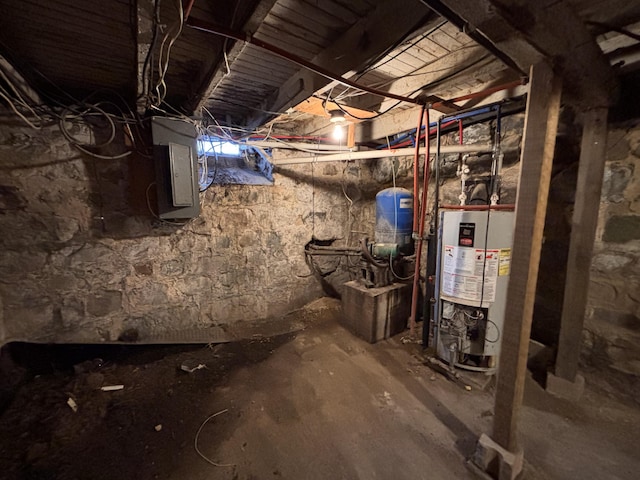 basement featuring water heater and electric panel