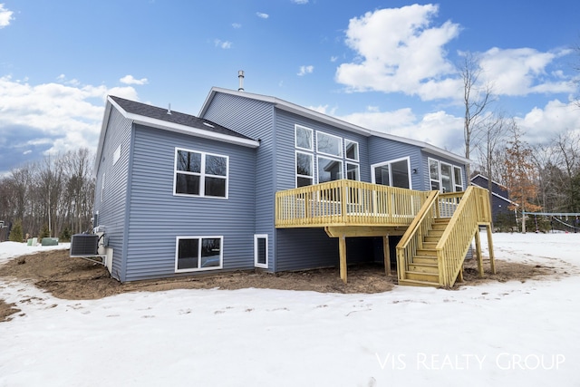 snow covered back of property featuring stairs, central AC unit, and a wooden deck