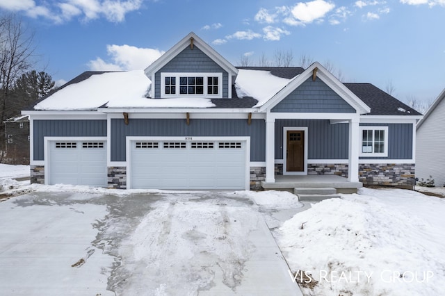 view of front facade featuring board and batten siding, stone siding, and a garage