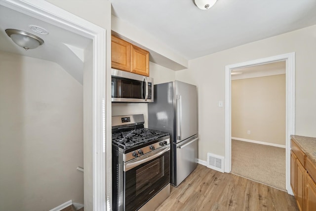 kitchen featuring light hardwood / wood-style flooring and appliances with stainless steel finishes