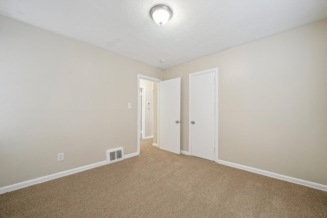 unfurnished room with carpet floors