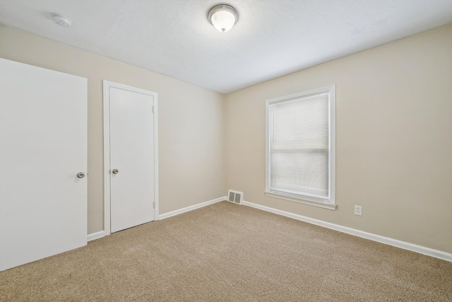 spare room featuring carpet flooring