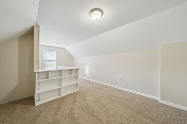 additional living space with lofted ceiling and carpet flooring