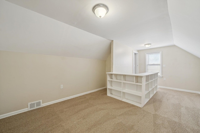 bonus room featuring carpet flooring and vaulted ceiling