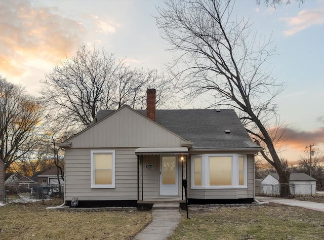 bungalow-style home featuring a lawn