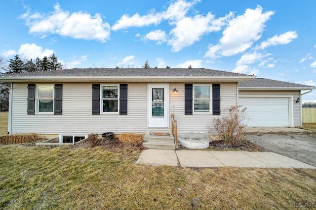 single story home featuring a garage and a front yard