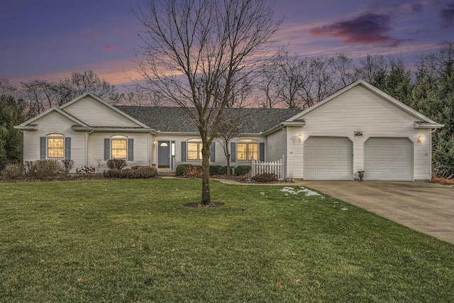 ranch-style house with a garage and a yard