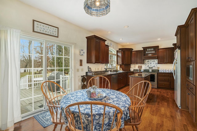 dining room featuring sink and dark hardwood / wood-style flooring