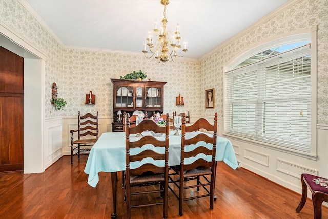 dining room with crown molding, dark hardwood / wood-style floors, and a chandelier