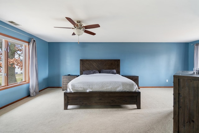 bedroom featuring light colored carpet and ceiling fan