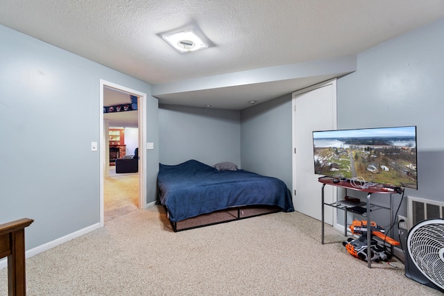 carpeted bedroom with a textured ceiling