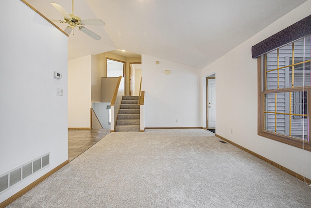 unfurnished room with vaulted ceiling, ceiling fan, and carpet floors