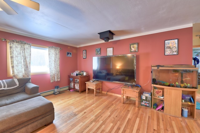 living room with a baseboard heating unit, hardwood / wood-style flooring, and ornamental molding