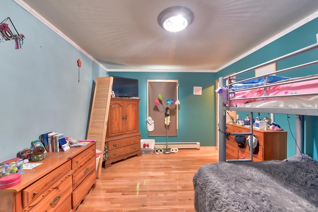 bedroom featuring a baseboard heating unit, ornamental molding, and light wood-type flooring