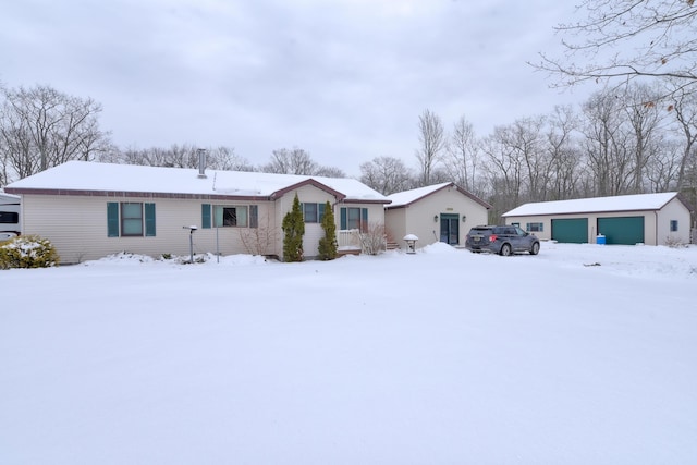 single story home with a garage and an outbuilding